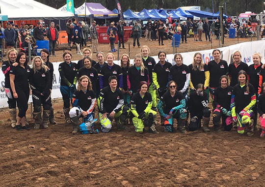 A team of Manjimup 15,000 motocross participants pose on a muddy track