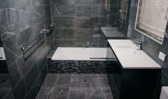 dark tile detail in small modern bathroom renovation