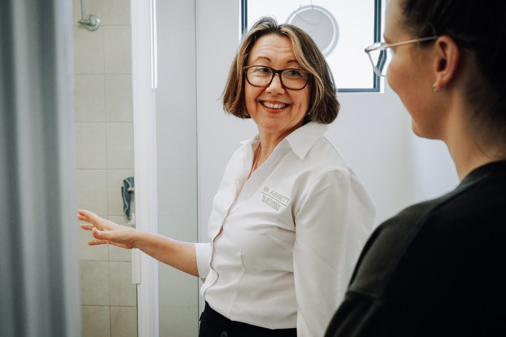 WA Assett team member talking to woman about shower