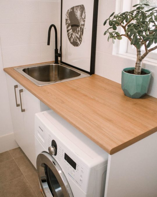 wooden bench tops in laundry with washing machine