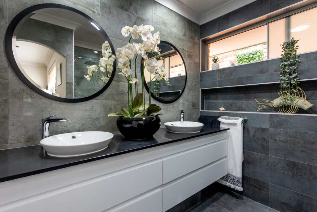 flowers and plants in modern grey and black bathroom