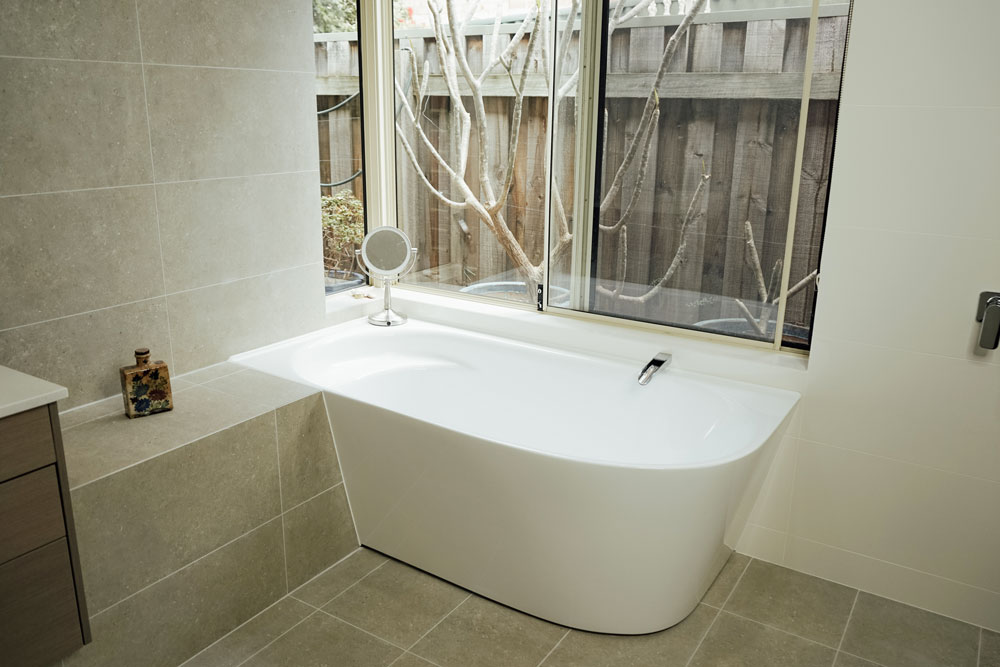 large bath with window above it