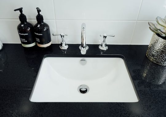 modern black sink with shiny taps