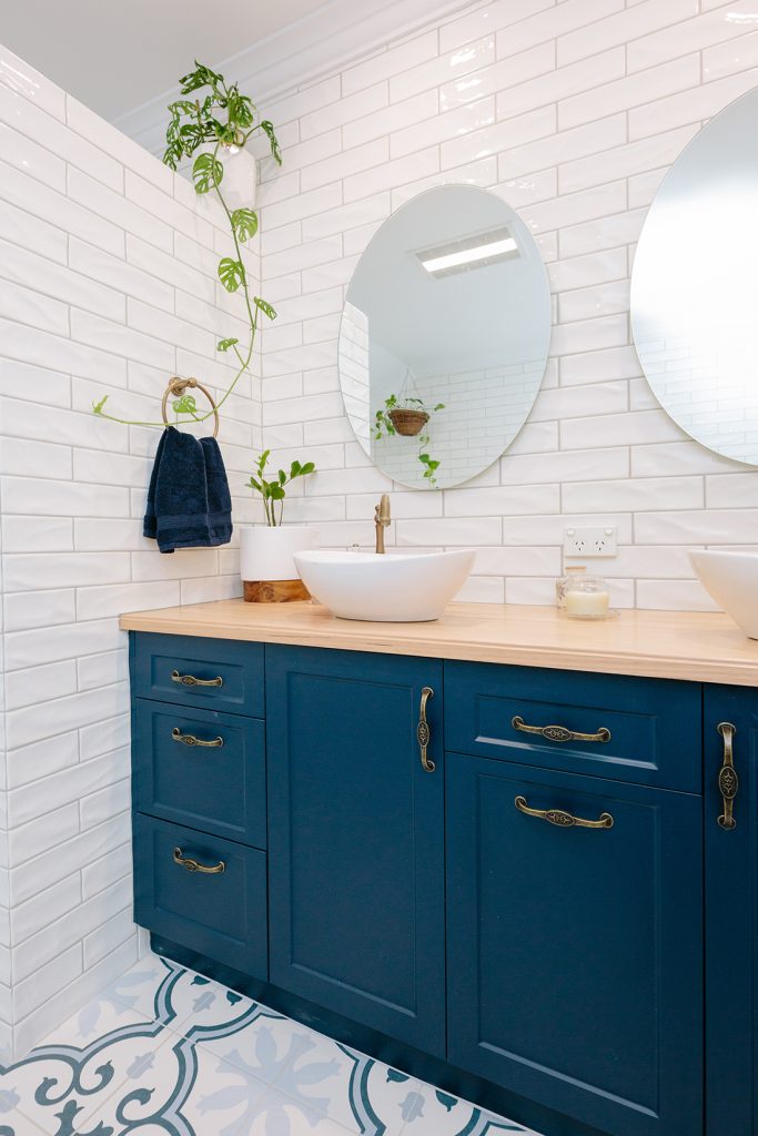 blue cupboards with white sinks above