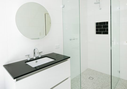 white bathroom with black tiles