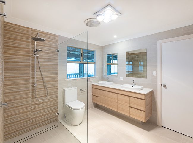 Narrow bathroom with twin vanities and large shower