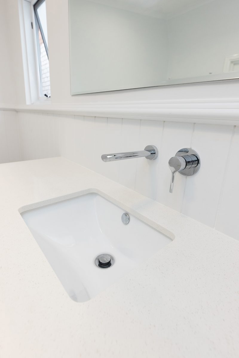 A sleek undermount sink with chrome tapware