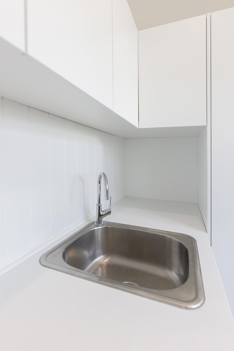 A drop-in laundry sink with chrome tapware
