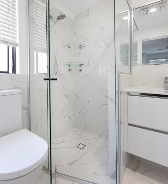 Spacious marble bathroom with hexagonal shower