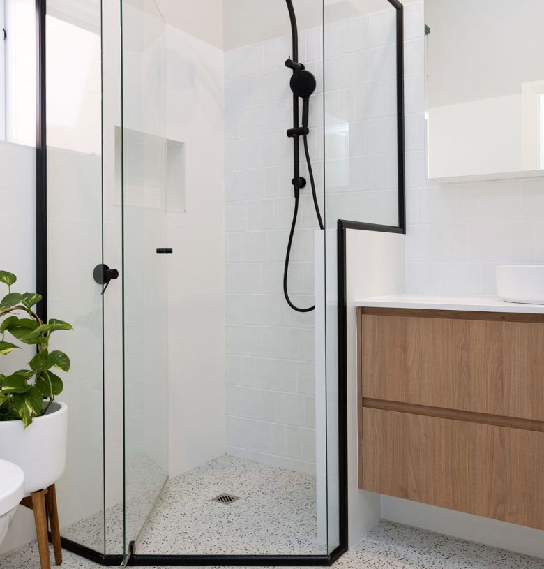 A spacious shower with a black frame renovated by WA Assett Team.