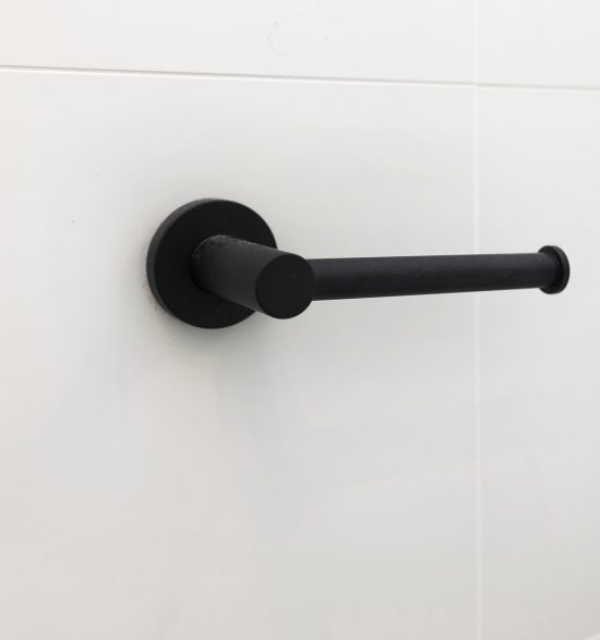 Bathroom renovation by WA Assett. A black handle on a wall in a bathroom.