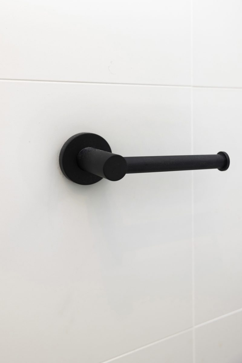Bathroom renovation by WA Assett. A black handle on a wall in a bathroom.