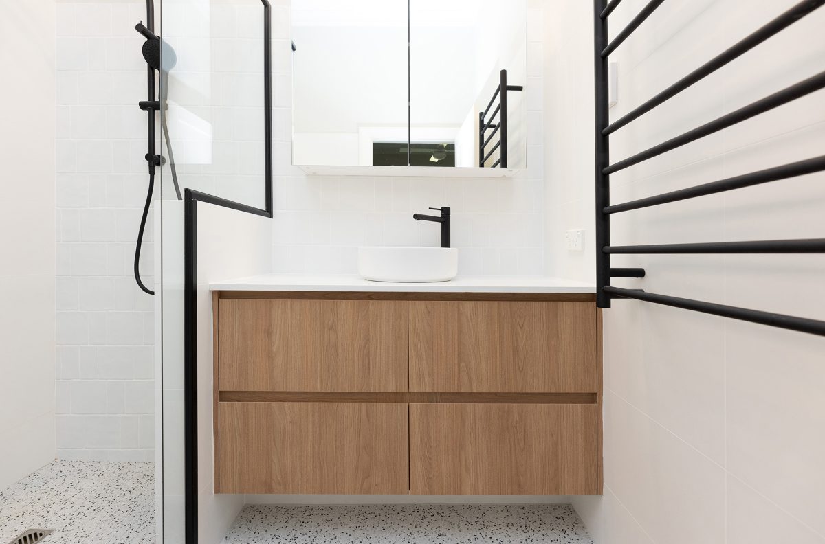 Bathroom project by WA Assett in Wembley, white sink and mirror above it.