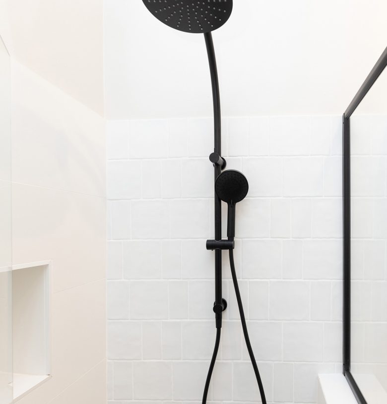 WA Assett Wembley - 010 Bathroom renovation, black shoer head and creamy white wall tile.