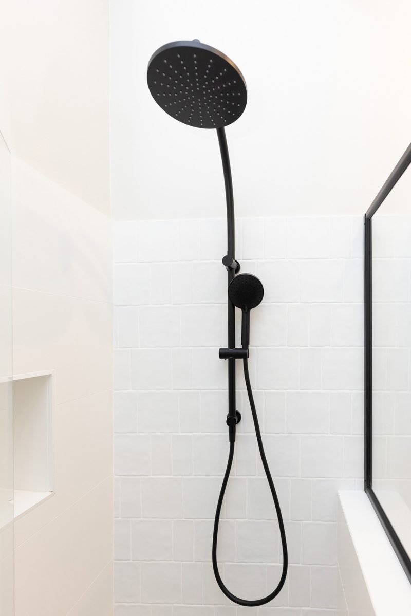 WA Assett Wembley - 010 Bathroom renovation, black shoer head and creamy white wall tile.