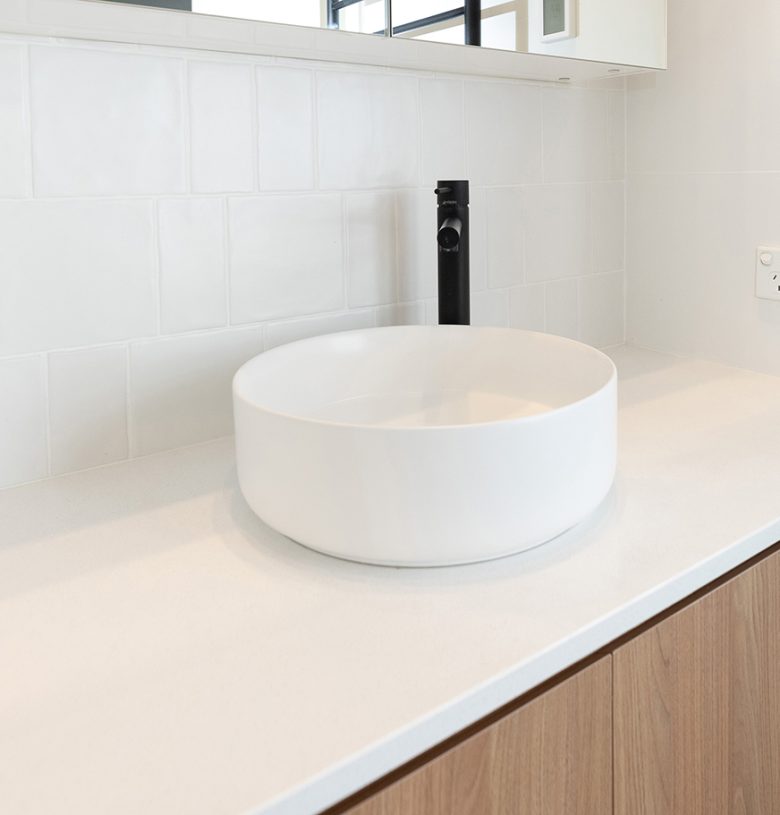WA Assett Wembley - 014 Bathroom renovation, vanity with a black tap and white wall tile.