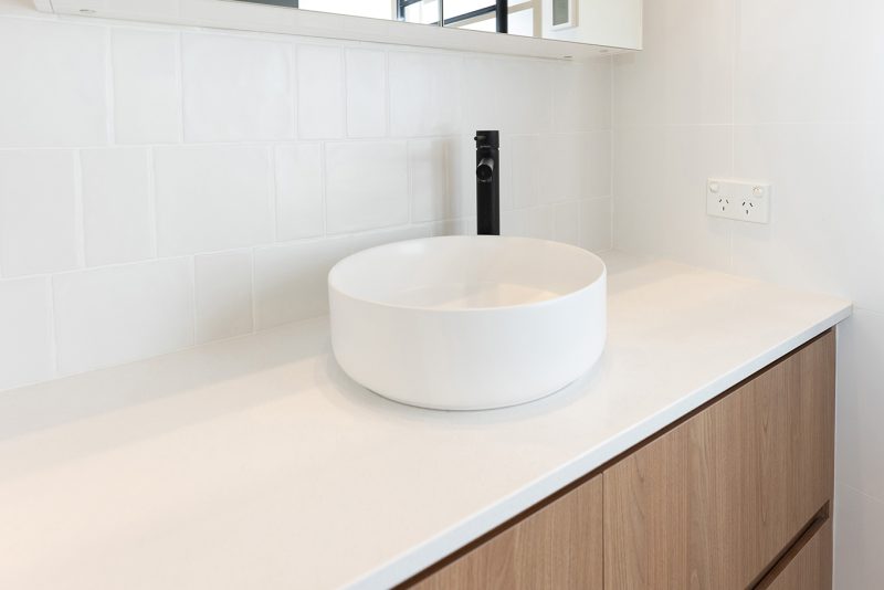 WA Assett Wembley - 014 Bathroom renovation, vanity with a black tap and white wall tile.