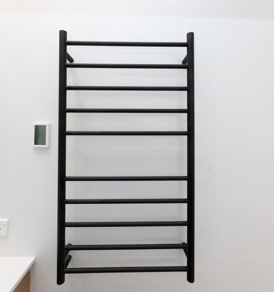 Bathroom renovation, Black towel rail fitted in white wall tile.
