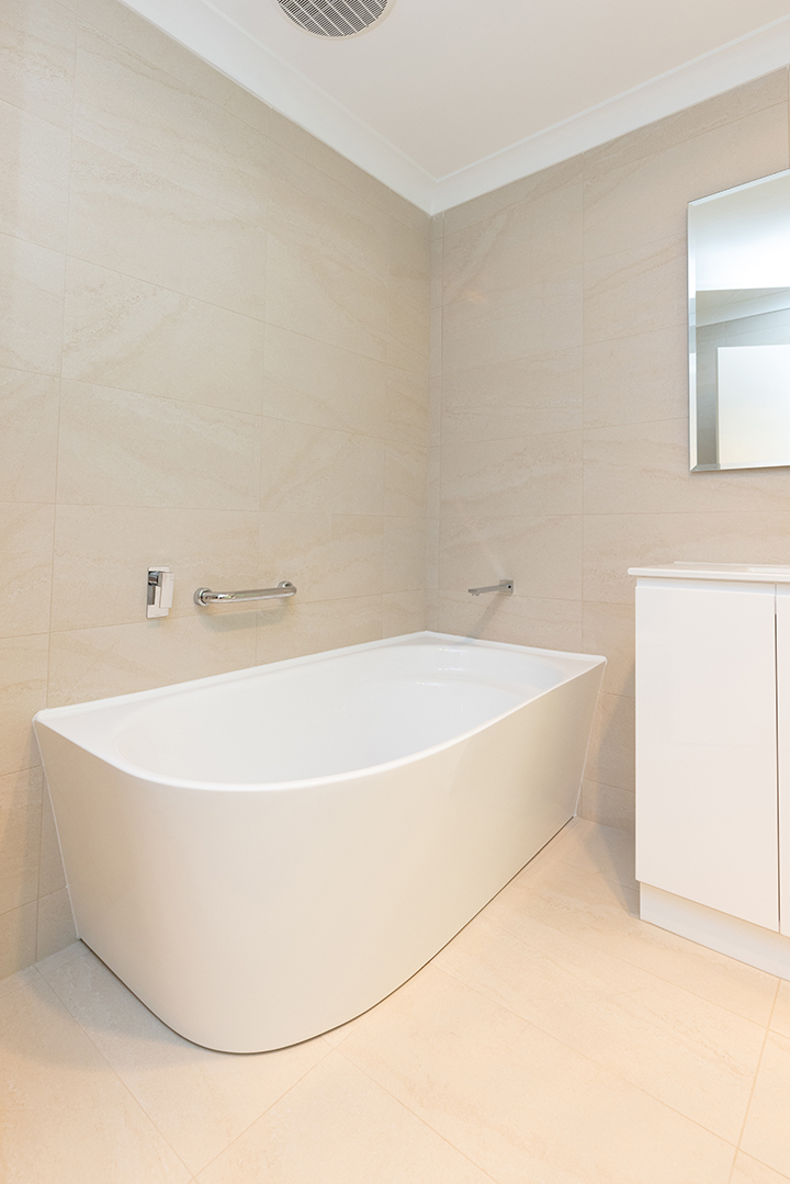 Large bath in white and cream bathroom