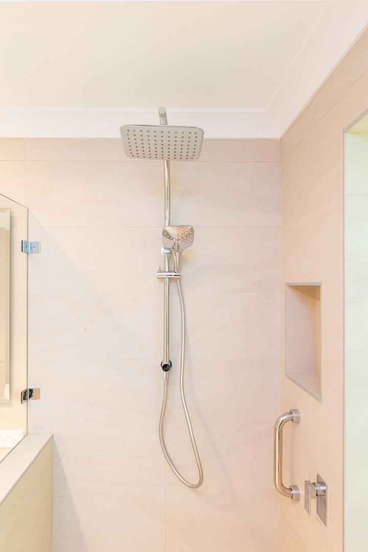 Large square rainfall shower head in shower with accessible bathroom supports