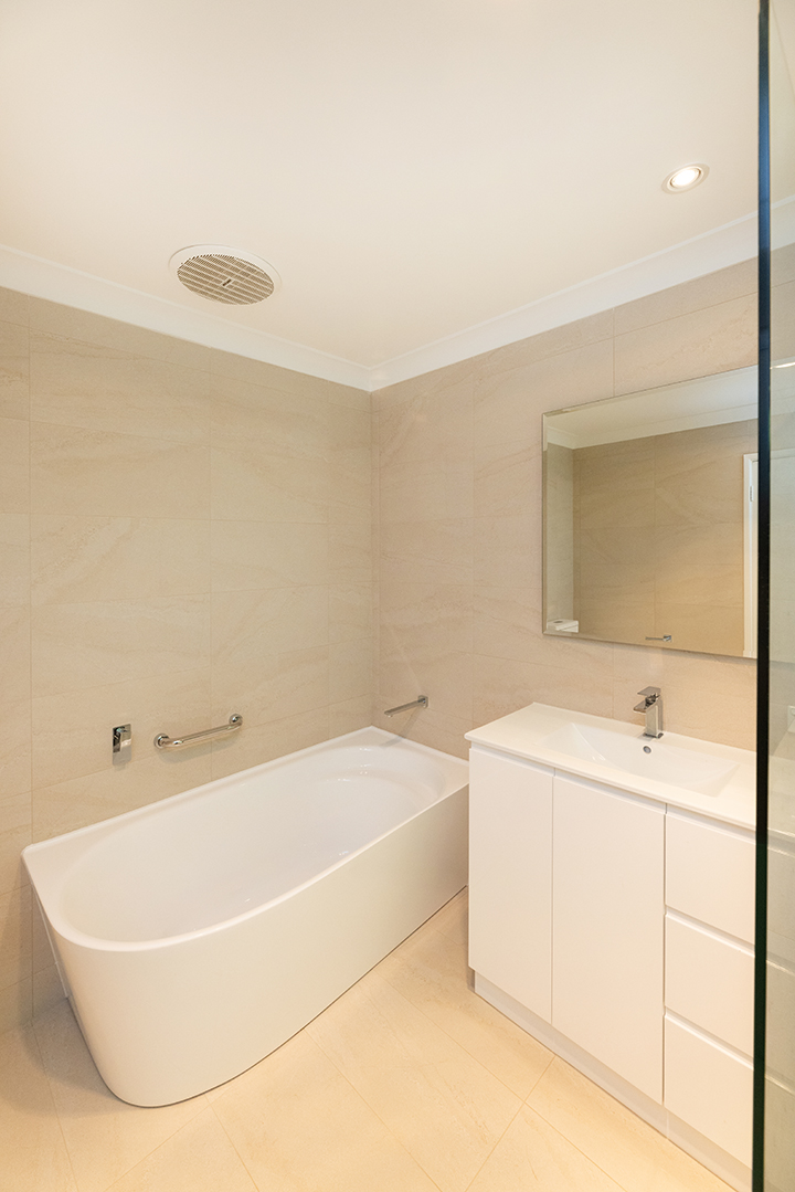 Bath and vanity in cream coloured bathroom