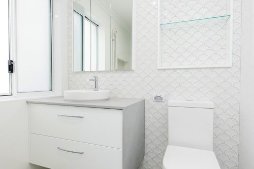 Polished white bathroom with vanity and toilet