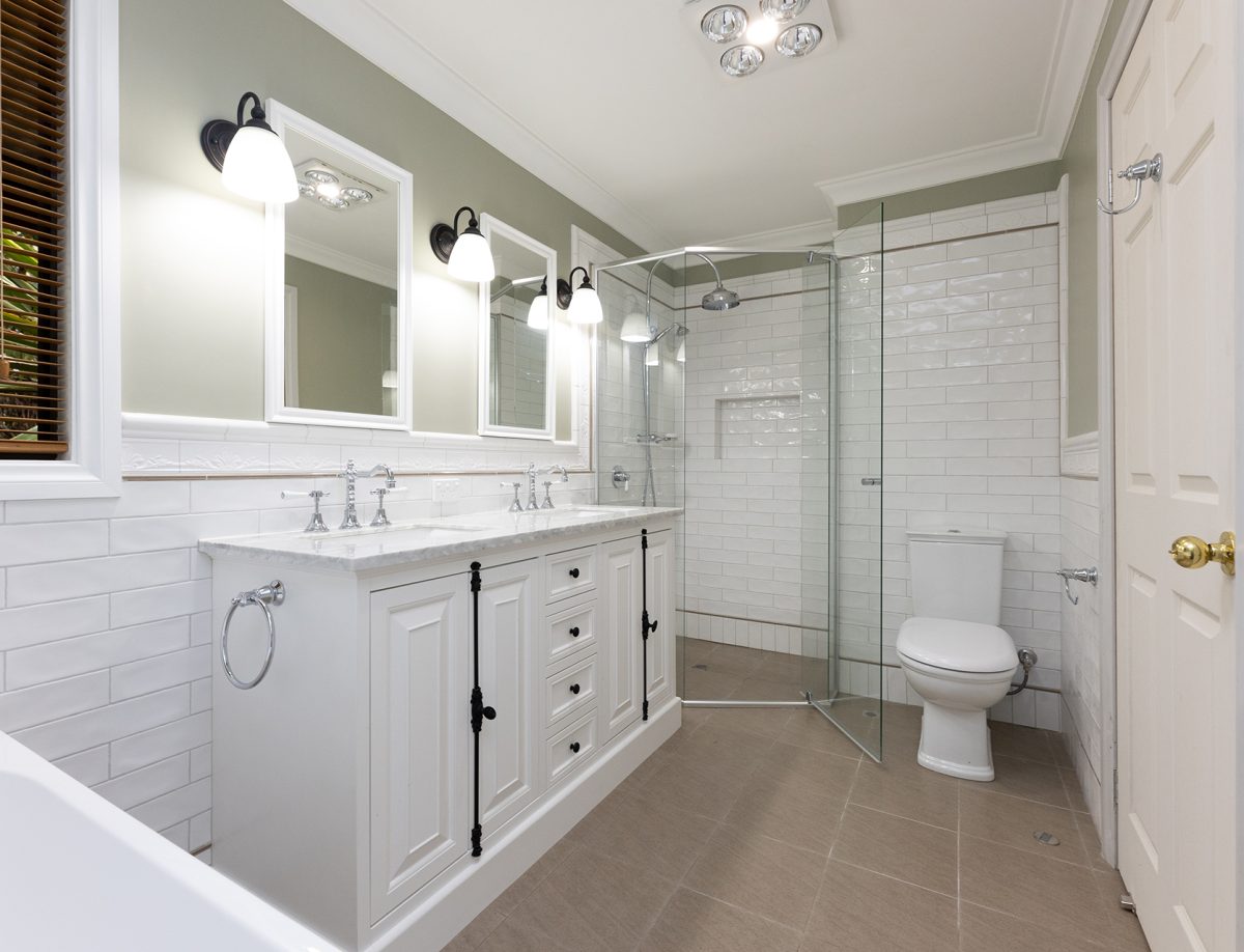 Large shower and dim lighting in a spacious bathroom