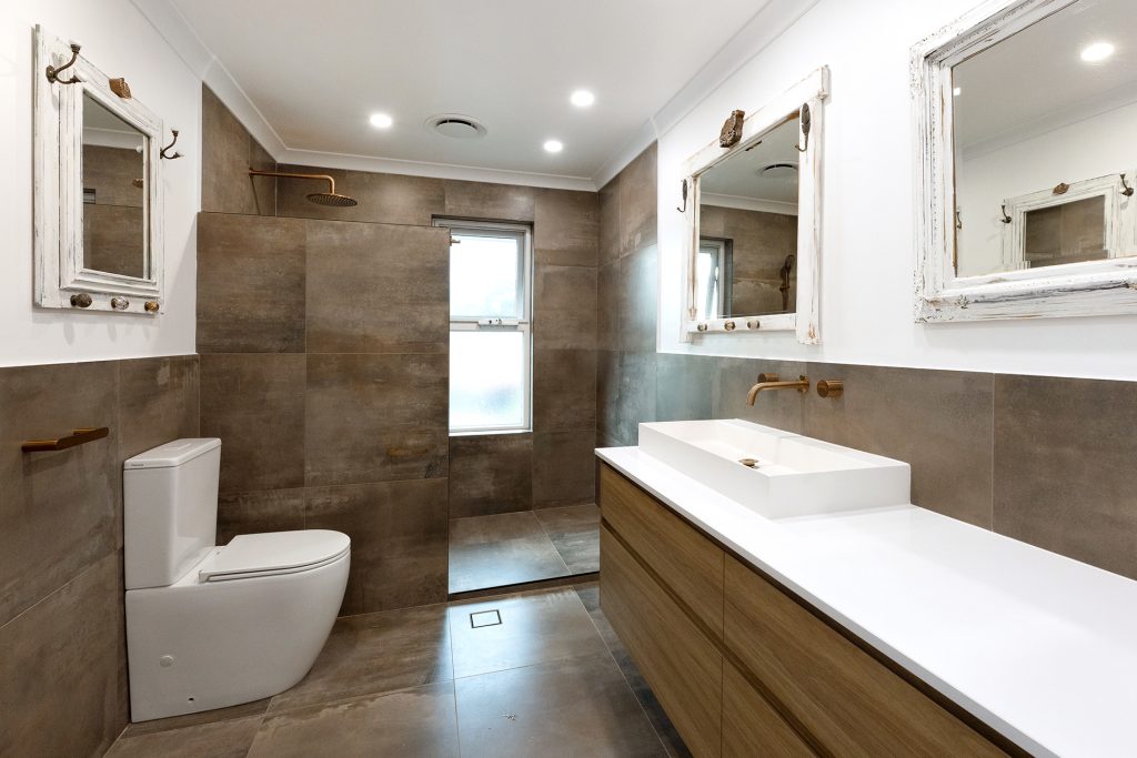 WA Assett bathroom renovation with smooth darker textures mixed with white and vintage worn mirrors