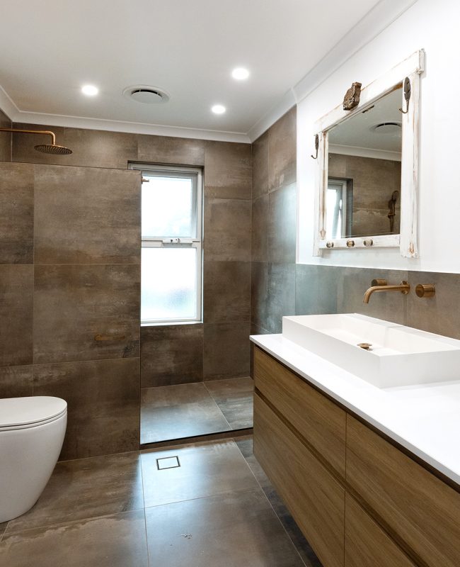 WA Assett bathroom renovation with smooth darker textures mixed with white and vintage worn mirrors