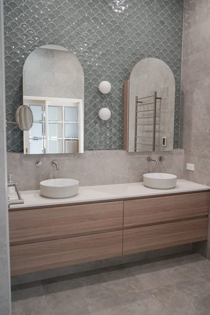 Bathroom renovation, 2 white basin and greyish green wall tile.