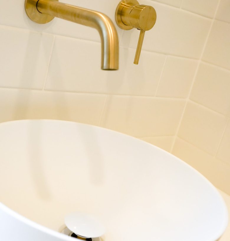 Nedlands CARRATHURS - 10 bathroom renovation, white basin and golden shower mixer tap.