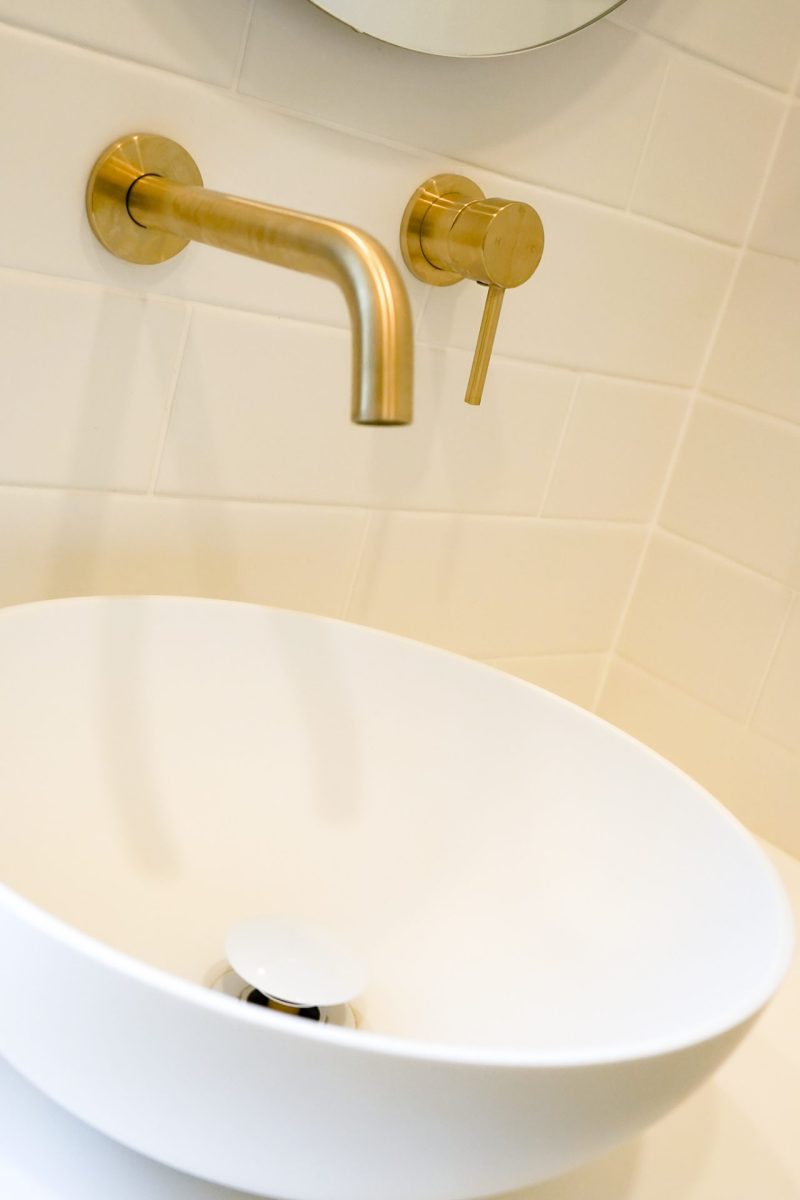 Nedlands CARRATHURS - 10 bathroom renovation, white basin and golden shower mixer tap.