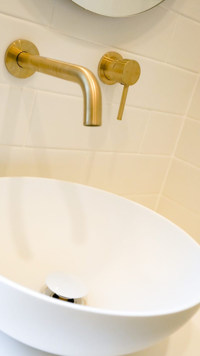 Nedlands CARRATHURS - 10 bathroom renovation, white basin and golden shower mixer tap.