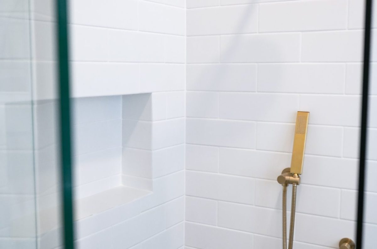 Nedlands CARRATHURS 29 bathroom renovation, golden shower head and white wall tile.