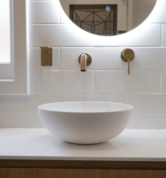 Nedlands Carrathurs bathroom renovation, white basin and golden basin mixer tap.
